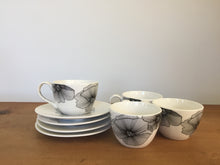 Load image into Gallery viewer, Black and white tea cups and saucers