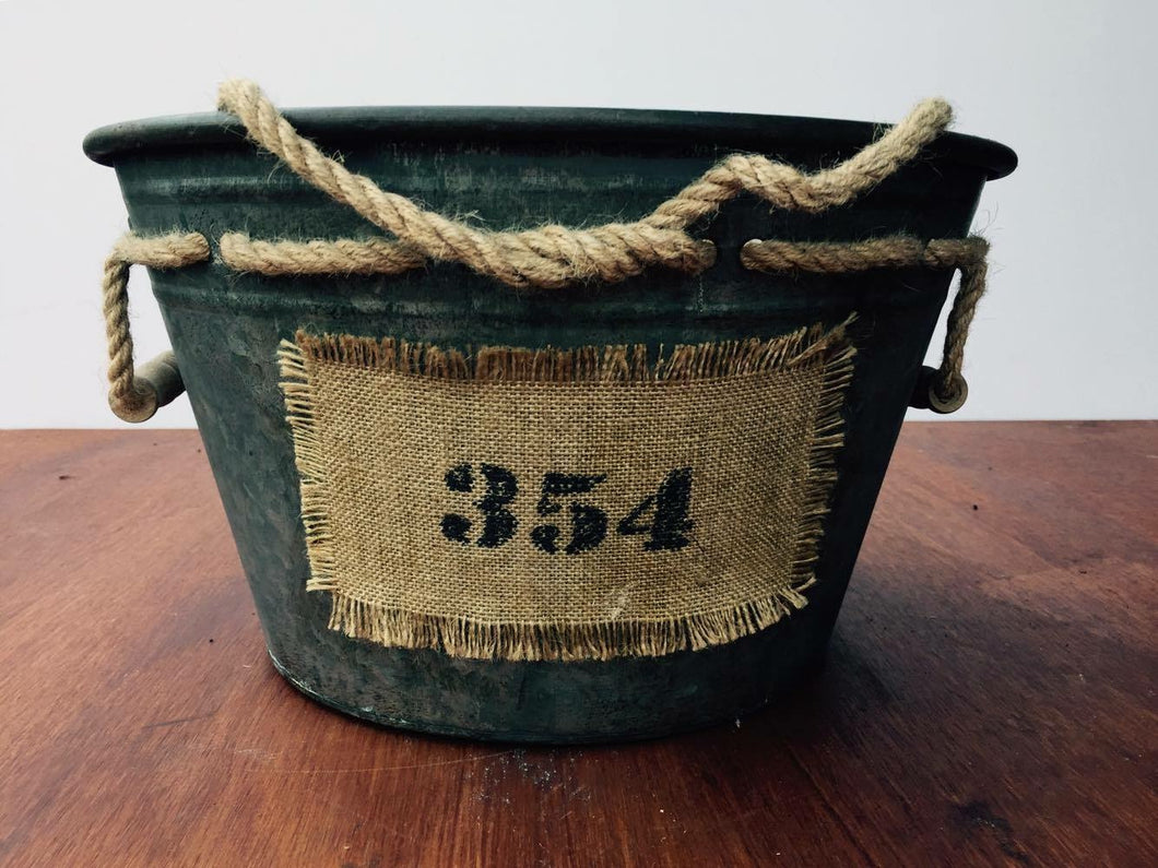 Metal tub with 354 hessian label